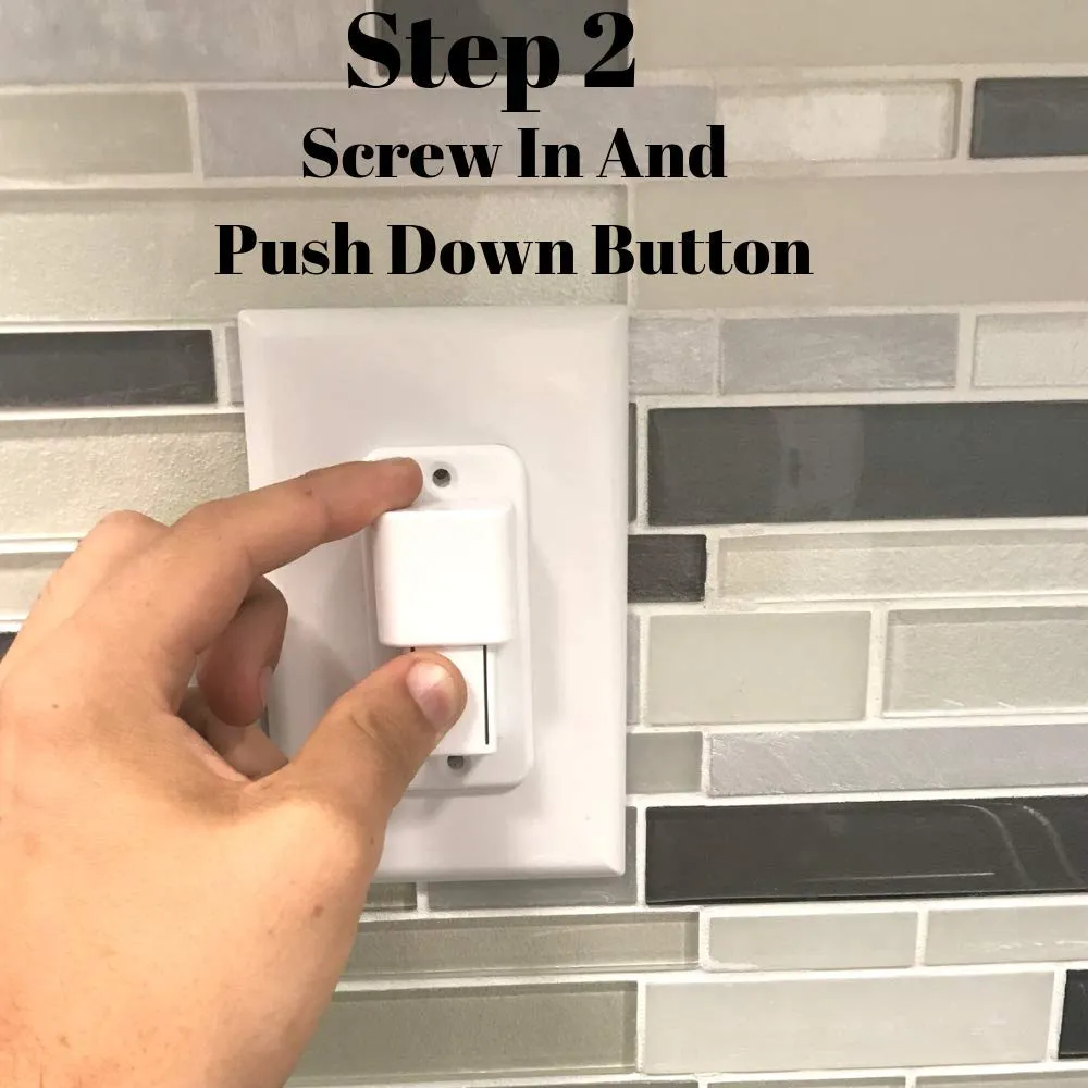 A hand pressing the button on the installed cover with the index finger.